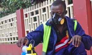 Ebola Response Worker with a Respirator and No Gloves