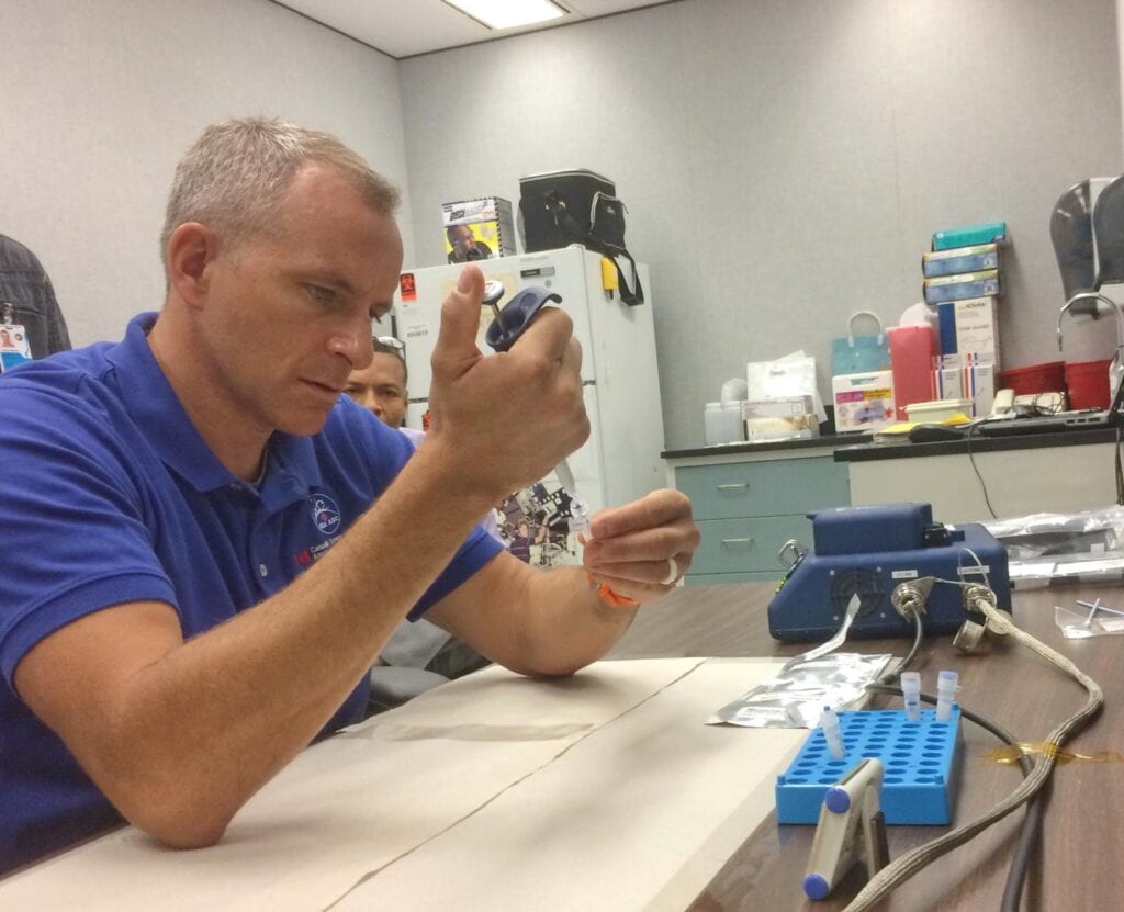 CSA astronaut David Saint-Jacques preparing a sample during pre-flight training