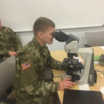 Pfc. Jace Pierce, a mechanic for the 1st Area Medical Laboratory, learns how to use a microscope to evaluate malaria samples. Credit: David Doubek 1st AML Operational Clinical Infectious Disease Course