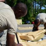 U.S. Air Force Staff Sgt. Matthew Bryles, 633rd Civil Engineer Squadron emergency management technician, and U.S. Air Force Senior Airman Bryce Carter, 633rd CES heating, ventilation and air conditioning technician, assemble tent components at Joint Base Langley-Eustis, Virginia. Credit: Monica Roybal EMEDS Assembly at Joint Base Langley-Eustis